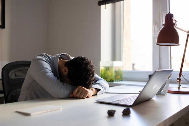 Side view anxious man on desk