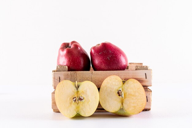 Side view apples half sliced in crate