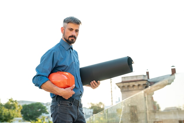 Free photo side view of architect holding blueprints