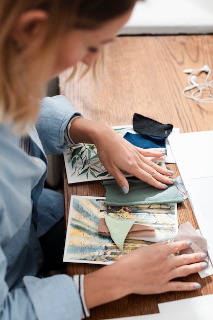 Side view of artist working at desk