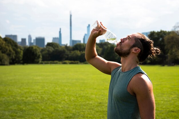 Side view of athlete drinking water