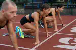 Free photo side view athletes ready to run