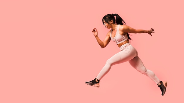 Side view of athletic woman jumping