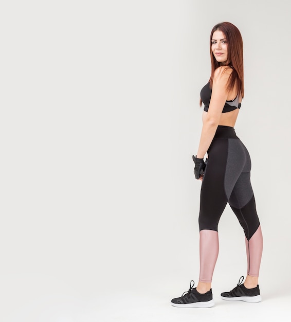 Side view of athletic woman posing while wearing athleisure