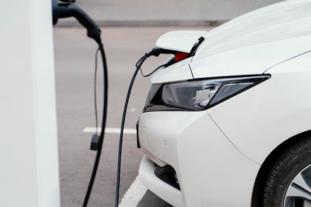 Side view of automobile being charged at electric vehicle charging station