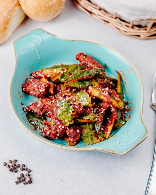 Side view of avocado salad with meat and sesame