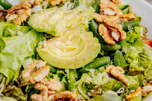 Side view of avocado salad with walnuts