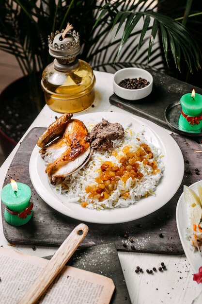 Side view of azerbaijani pilaf with roasted chicken lyavangi and roasted dried fruits