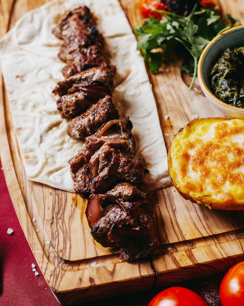 Side view of azerbaijani style beef kebab on lavash