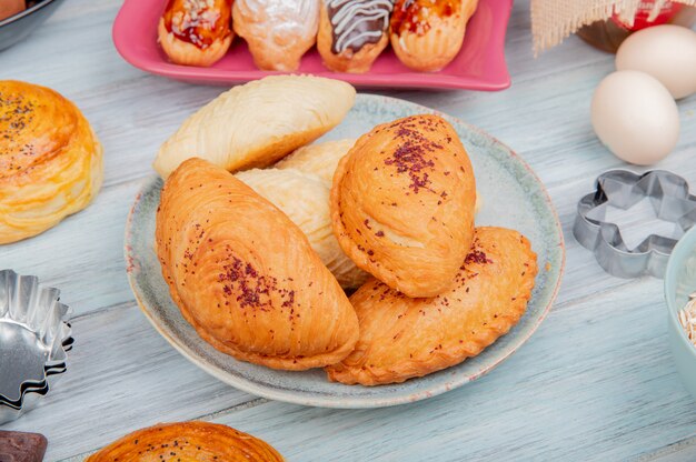 side view of bakery products as badambura shakarbura goghal in plate eggs cakes on wooden