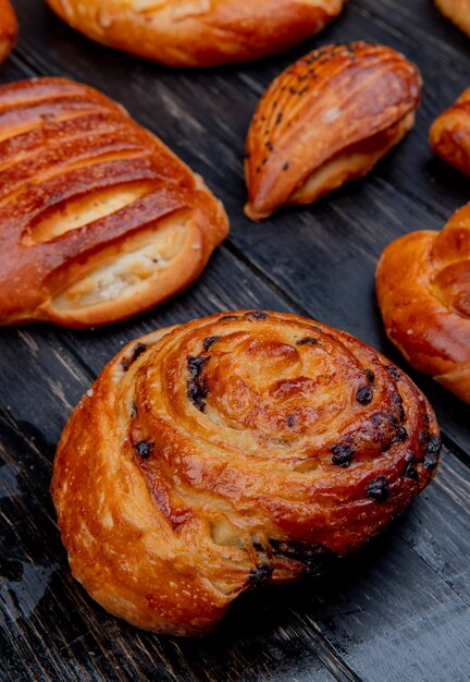 Side view of bakery products as roll and others on wooden