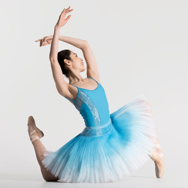 Side view of ballerina dancing in tutu dress