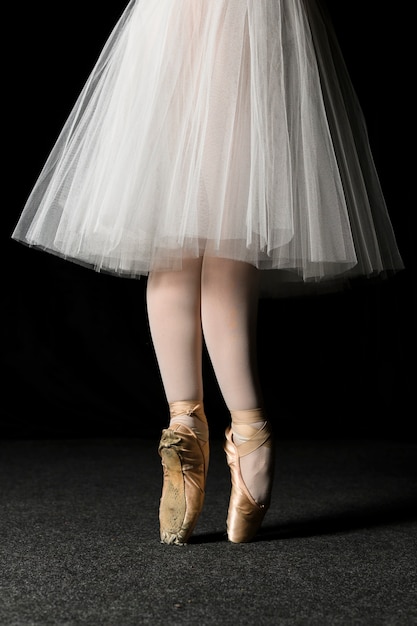 Free photo side view of ballerina feet with pointe shoes