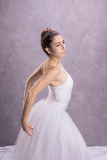 Side view ballerina stretching her back