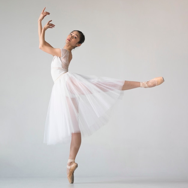 Side view of ballerina in tutu dress posing