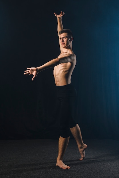 Side view of ballerino dancing in tights