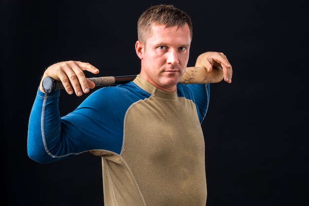 Free photo side view of baseball player holding bat