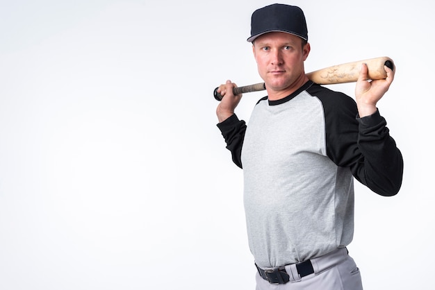 Side view of baseball player with cap and bat