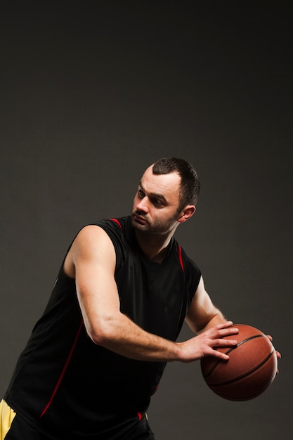 Side view of basketball player with ball and copy space