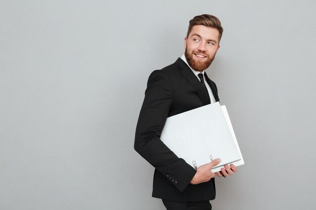 Side view of a bearded man in suit