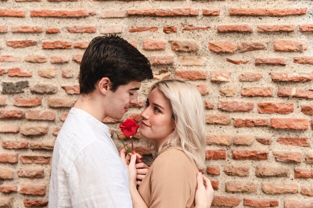 side view of beautiful couple with rose