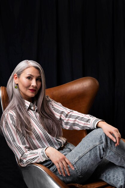 Side view beautiful senior woman portrait posing on chair