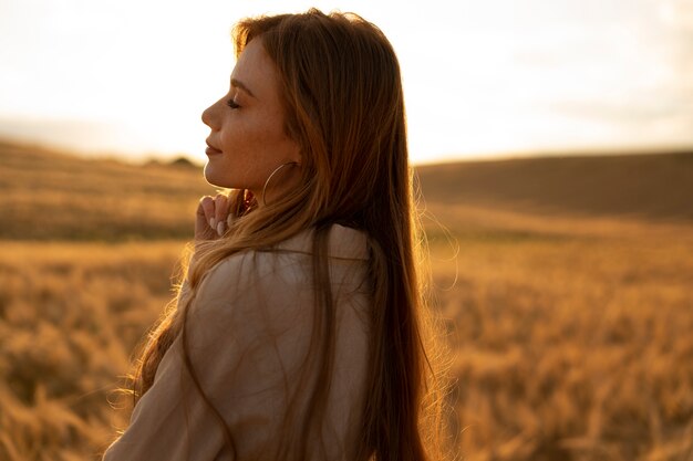 Side view beautiful woman posing outdoors