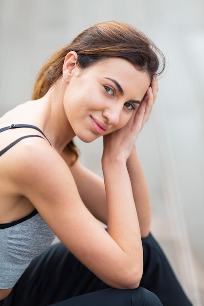 Side view of beautiful woman posing while exercising outdoors