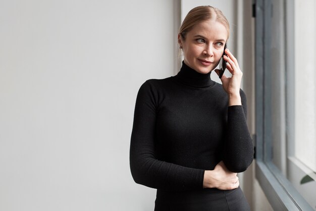 Side view beautiful woman talking over phone