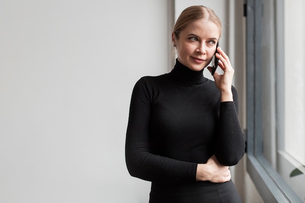 Side view beautiful woman talking over phone