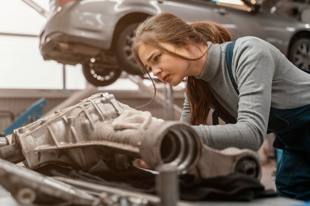 Side view beautiful woman working at a car service