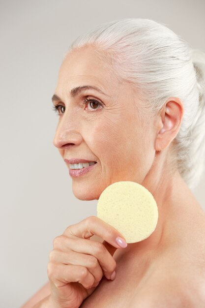 Side view beauty portrait of a half naked elderly woman