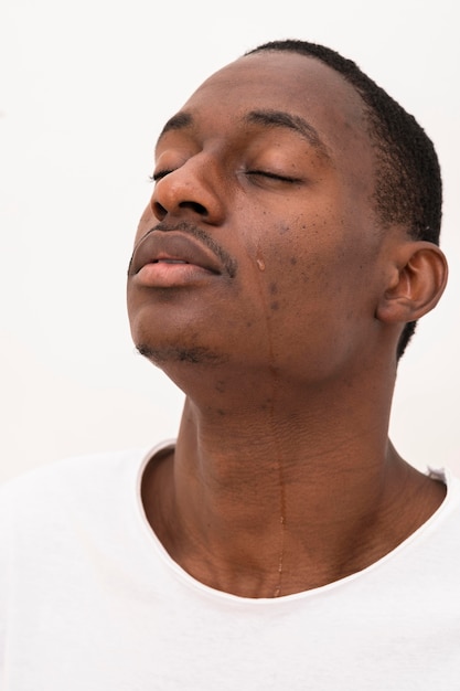 Side view of black man crying