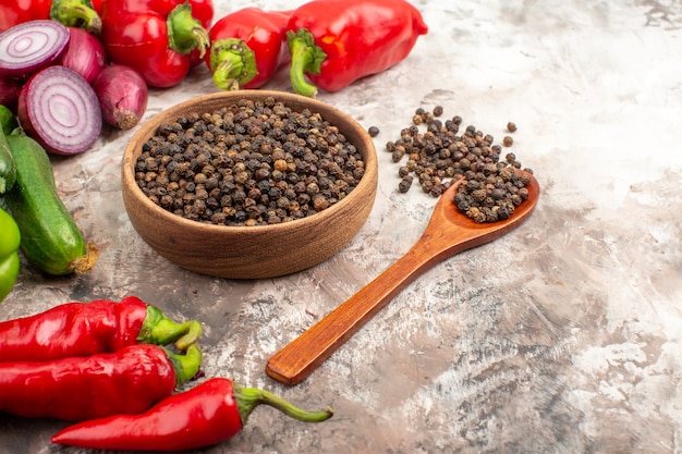 Free photo side view of black pepper various chopped and whole