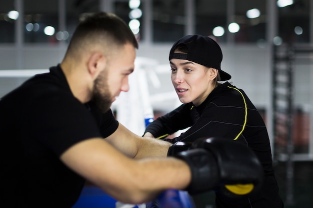 Side view of boxer and trainer having a conversation