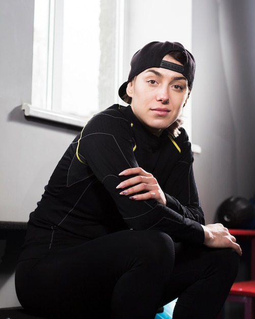 Free photo side view of boxer trainer posing while sitting down