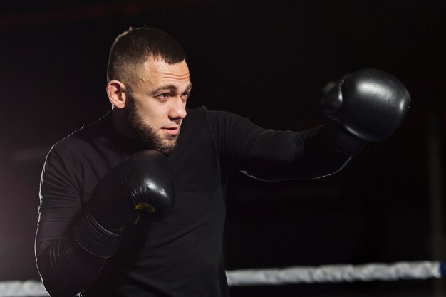 Side view of boxer training in protective gloves