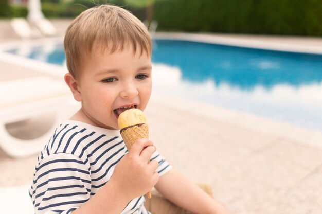 Side view boy eating ice cream