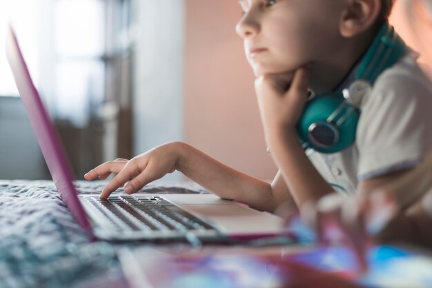 Side view of boy using laptop