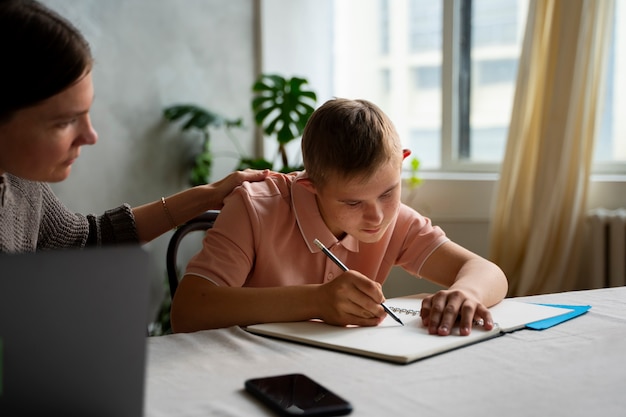 Side view boy and woman with laptop