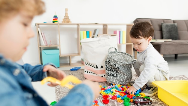 Side view of boys at home playing with toys