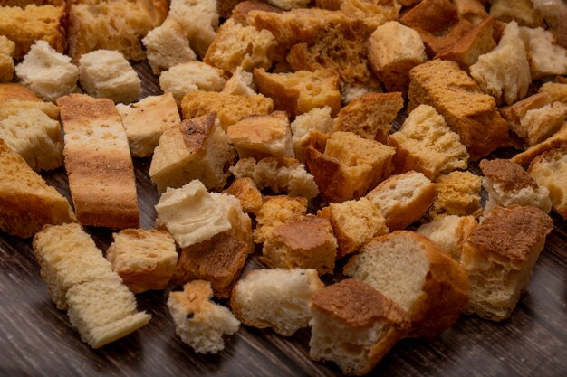 Side view of bread pieces on wooden background