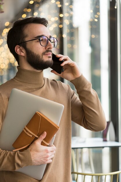 Free photo side view business man talking over phone