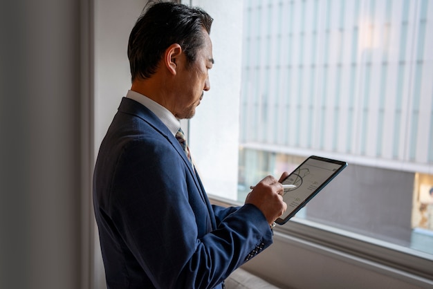 side view business man working on ipad