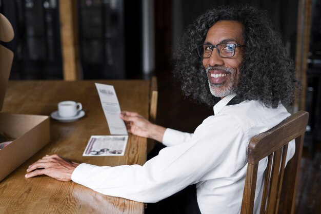 Side view business owner sitting at table