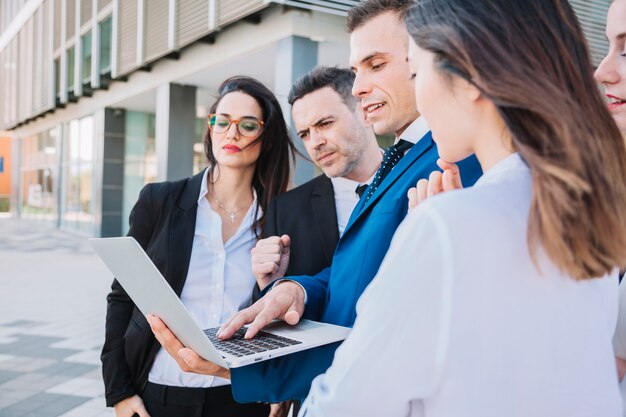 Side view of business team with laptop