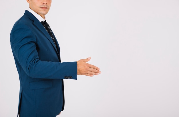 Side view of businessman reaching out hand