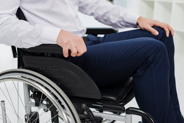 Side view of a businessman sitting on wheelchair