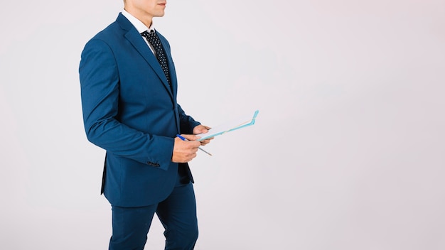 Side view of businessman with clipboard