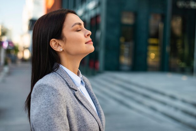 Side view of businesswoman outdoors in the city with copy space